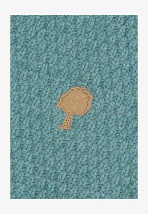 Tessuto blu lavorato a maglia con una piccola forma di albero marrone chiaro ricamata al centro.