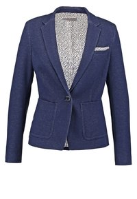 Blazer ajusté bleu marine avec fermeture à un bouton, deux poches plaquées à l'avant, doublure intérieure blanche à motif et pochette assortie.