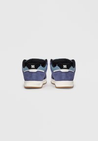 Blue suede skate shoes with black accents, cushioned ankle support, and white midsoles. Low-cut design with textured detailing on the upper.