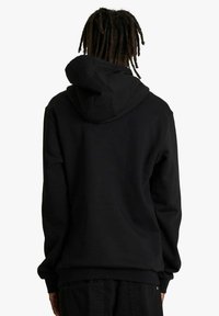 Felpa nera con cappuccio ampio e curvo e polsini a coste. Realizzata in tessuto morbido, presenta una texture liscia e una vestibilità comoda.