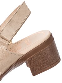 Beige open-toe sandal with adjustable ankle strap and chunky brown textured heel.