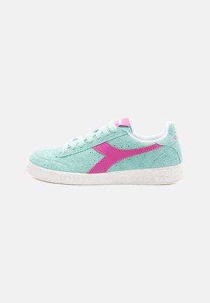Light blue suede sneaker with pink accents, featuring a white rubber sole, round toe, and lace-up closure.