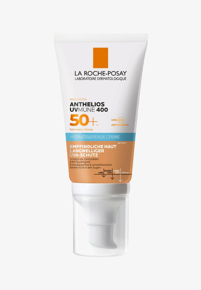 Sunscreen tube with a white and orange design. Contains UV protection text, 50+ SPF label, and a pump dispenser. Smooth, glossy finish.
