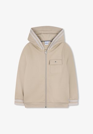 Beige hoodie met ritssluiting, gemaakt van een gestructureerde stof, met een grote kap en witte streeppatronen op de kap en manchetten; voorzien van een voorzak.