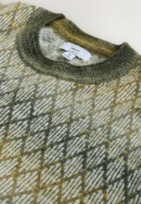 Wool sweater with a diamond pattern in green and beige hues. Features a rounded collar and a label indicating size and brand. Soft texture.