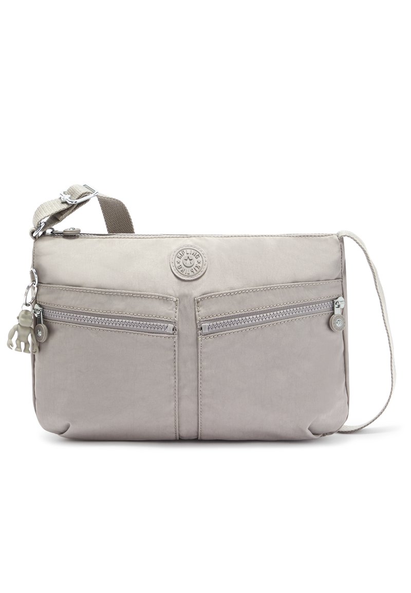 Light grey crossbody bag made of nylon, featuring two front zip pockets, a logo patch, and a hanging charm. Adjustable strap included.