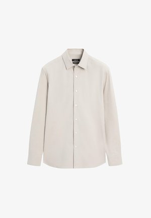 Beige Langarm-Hemd mit Knopfleiste, spitzem Kragen und sichtbaren weißen Knöpfen, flach auf einem weißen Hintergrund ausgebreitet.