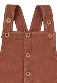 Braune Kordoveralls mit breiten Trägern, ausgestattet mit Holzknöpfen und einem strukturierten Stoff. Das Design ist einfach und funktional.