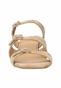 Beige suède sandalen met meerdere banden, opvallende knopen en een platte zool, met een glad interieur en open zijkanten.