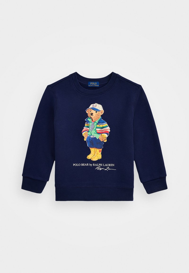 Sweatshirt azul marinho com um gráfico colorido de um urso vestido com uma jaqueta às riscas, com punhos canelados e gola arredondada. "Polo Bear by Ralph Lauren" impresso abaixo.