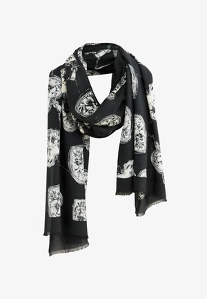 Fekete sál, amelyet fehér virágminták és bonyolult dizájnelemek díszítenek, könnyű anyagból készült, rojtos szélekkel.