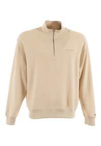 Pull en polaire beige avec un col haut, un zip demi-longueur à l'avant, des poignets et un ourlet côtelés. Présente un tissu texturé et un logo discret.