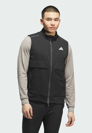 Black athletic vest with a zip front, gray long sleeves, and Adidas logo. Features smooth fabric, a high collar, and side pockets.