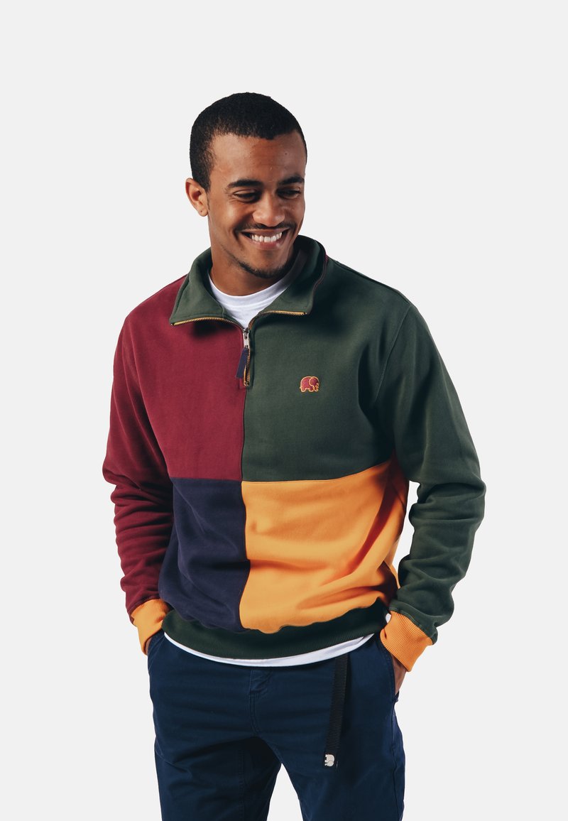 Vaatettu fleece-collegepaita, jossa on burgundy-, vihreä-, laivaston- ja oranssit värit. Nelláttu vetoketju ja brodeerattu norsulogo.