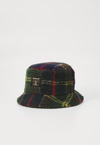 Groene, rode en marineblauwe geruite fleece bucket hat. Heeft een zwart label met logo aan de zijkant. Zachte textuur, brede rand.