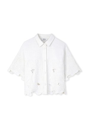 Chemisier cropped en lin blanc avec fermeture à boutons et ourlet festonné. Présente des motifs en découpes florales et des designs brodés sur les panneaux avant.