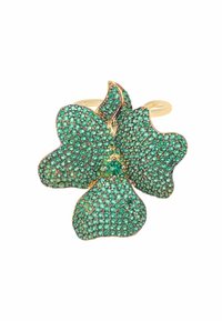 Gold-tone ring featuring a flower design, adorned with green gemstones in various sizes, creating a textured surface with intricate detailing.