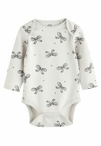 Body bébé blanc à manches longues avec un nœud noir et motif à pois, avec des boutons-pression en bas pour faciliter le change.