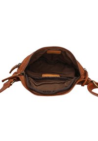 Brown leather handbag with a zippered opening, interior compartments, and a soft fabric lining. Features a sturdy strap and smooth texture.