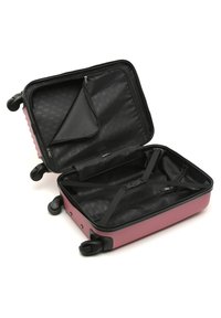 Hard-shell suitcase in pink, featuring interior zip pocket and adjustable straps against a black fabric lining. Smooth-rolling wheels included.