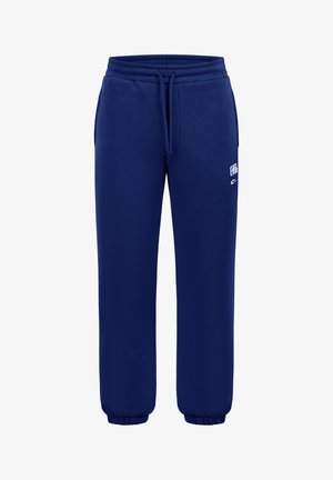 Pantalon de survêtement bleu marine avec taille élastique, cordon de serrage, poches latérales et petit logo brodé sur la cuisse droite.