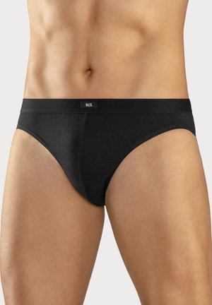 Schwarze Unterwäsche aus weicher Baumwolle, mit einem tief geschnittenen Design und einem strukturierten, elastischen Taillenbund mit einem kleinen Logo-Aufnäher.