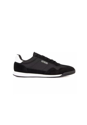 Black and white low-top sneaker with lace-up design, fabric and suede upper, and "GUESS" logo on the side.