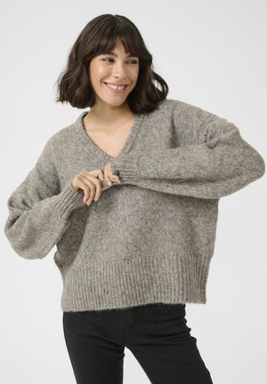 Gray knitted sweater with a V-neck, loose fit, and ribbed cuffs and hem. The texture is soft and fuzzy, creating a cozy appearance.