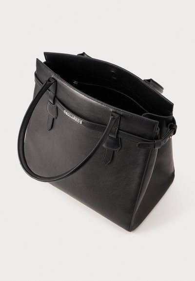 Black leather tote bag with dual handles, featuring a spacious interior and a zip pocket. Simple design with embossed logo on the front.