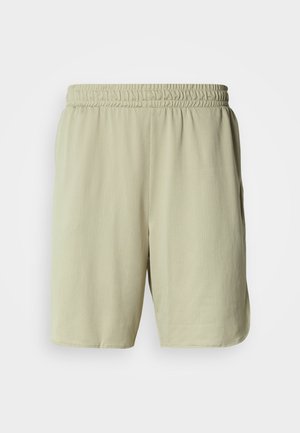 Svijetlo bež sportske kratke hlače od prozračnog, teksturiranog materijala. Imaju elastični pojas i bočne džepove za praktičnost.