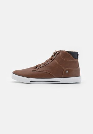 Brown leather high-top sneaker with white rubber sole, round toe, lace-up front, and contrasting black inner lining.