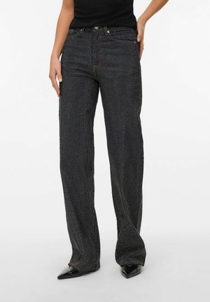 Schwarze Denim-Jeans mit schlanker Passform und geradem Bein, ausgestattet mit einem strukturierten Muster aus kleinen weißen Punkten und Akzentnähten.