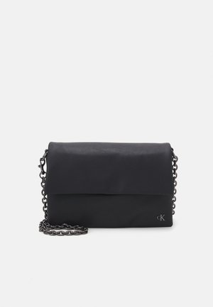 Black handbag with a fold-over design, made of smooth material. Features a chain strap and a subtle logo detail on the front.