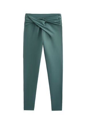 Hochtaillierte Leggings in dunkelgrün mit einem gedrehten Bunddesign, glatter Textur und figurbetontem Schnitt mit dezenten Raffungselementen.