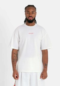 Witte oversized t-shirt van katoen, met korte mouwen en een ronde halslijn, versierd met een rood "SIXTH JUNE" logo op de voorkant.