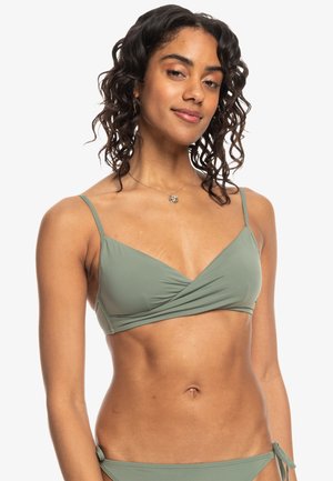Light green bikini top with a wrap design, thin adjustable straps, and smooth texture. Features a versatile style suitable for swimwear.