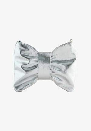 Shiny silver clutch bag shaped like a large bow with a central band and smooth metallic texture on a white background.
