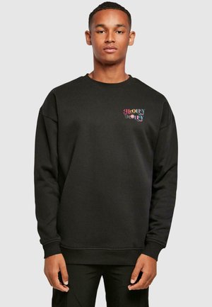 Black sweatshirt made of soft fabric, featuring a colorful "HOLLY JOLLY" graphic on the chest, with ribbed cuffs and hem.