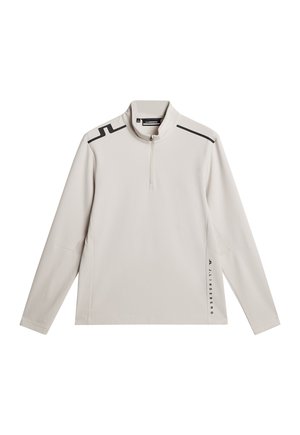 Hellbeige Pullover mit einem Viertelreißverschluss, langen Ärmeln und kontrastierenden schwarzen Schulterakzenten. Weicher Stoff mit slim fit.