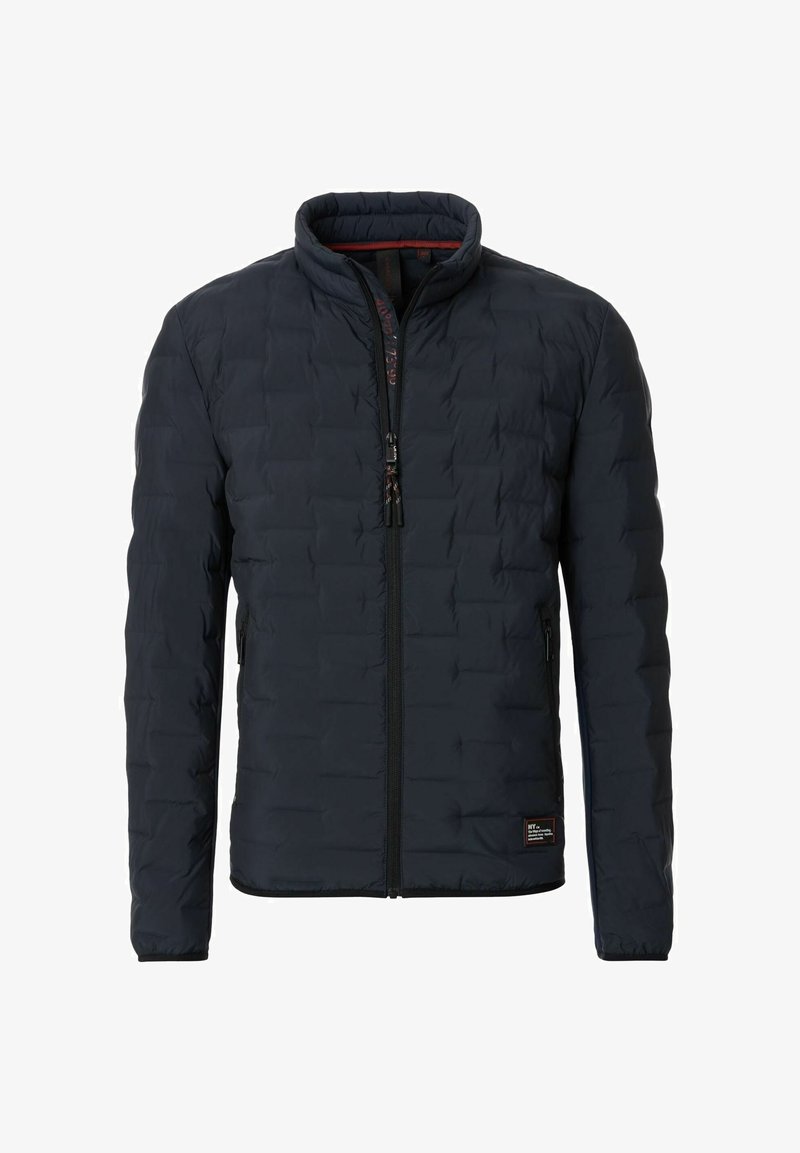 Polstret jakke i marineblå, med ståkrave, fuld lynlås, to sidelommer og et tekstureret quiltet design.