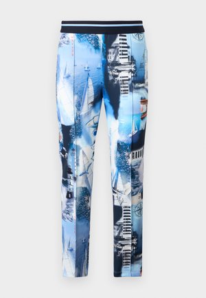 Colanți cu imprimeu nautic albastru, cu iahturi, faruri, pescăruși, busolă și clădiri de pe malul apei, cu talie albastru închis.