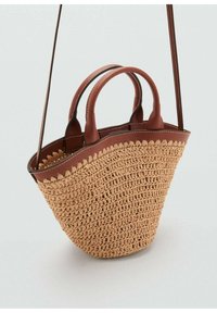 Woven straw tote bag with a rounded shape, tan color, and brown leather accents. Features double handles and a detachable shoulder strap.