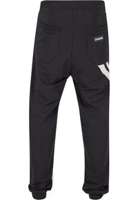 Dunkelgraue Sweatpants mit elastischem Bund, zwei Gesäßtaschen und weißen Seitenstreifen. Hergestellt aus weichem, strukturiertem Baumwollstoff.