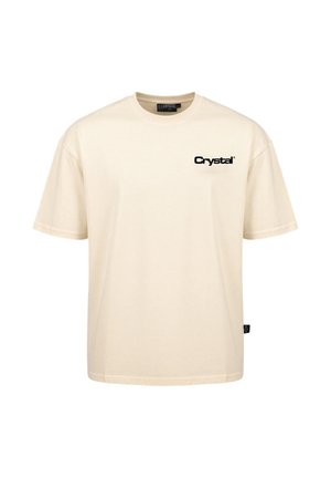 T-shirt color crema a maniche corte con scollo rotondo e logo testuale nero "Crystal" sul lato sinistro del petto.