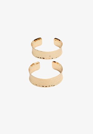 Gold-toned metal cuffs with a hammered texture, featuring an open design and smooth edges. Two sizes shown: one wider, one slimmer.