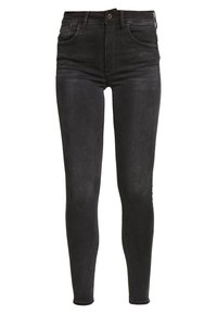 Pantalones vaqueros ajustados de tiro alto en negro, fabricados con algodón y elastano. Incluyen cinco bolsillos, un cierre de cremallera y detalles de desvanecimiento sutil.