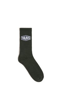 Dark green ribbed socks featuring a woven Vans logo in white and blue on the cuff. Made from a stretchy cotton blend for comfort.