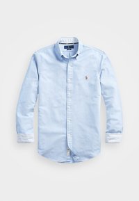 Ljusblå skjorta med knappar i bomull. Har lång ärm med randiga manschetter och en liten broderad logotyp på bröstet.
