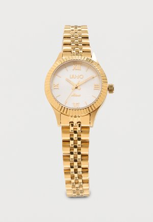 Montre-bracelet en métal doré avec cadran blanc, chiffres romains, marque "LIU·JO Miss" et bracelet à maillons.