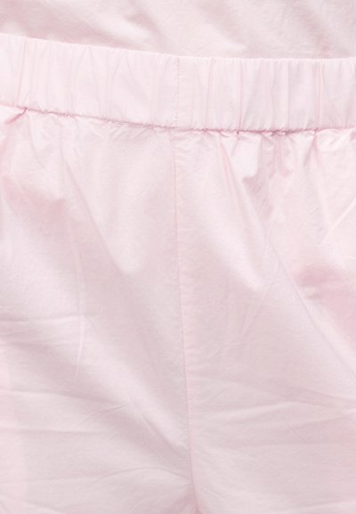 Ροζ ανοιχτό παντελόνι με ελαστική ζώνη, ύφασμα με λεία υφή και ορατές ραφές στην κεντρική ραφή.